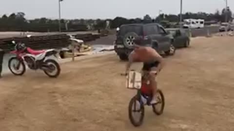 Guy rides his bike off a ramp into a lake