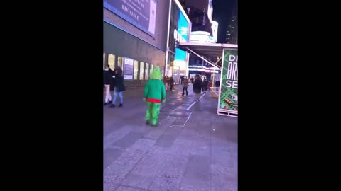 New Yorker wearing a Grinch costume walks around Times Square