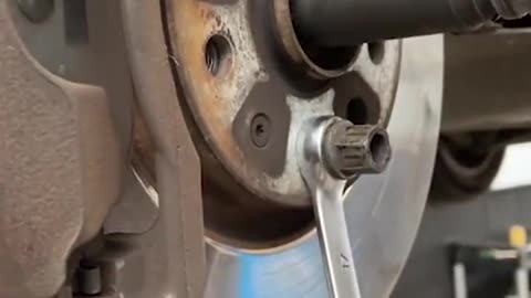 Remove large nut to secure brake disc