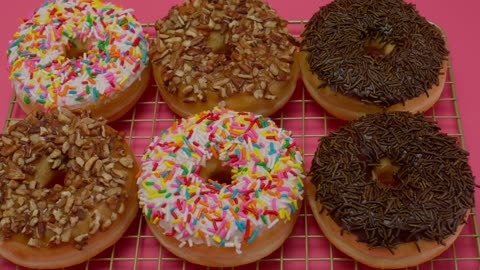 Donuts with various types of icing in a close up shot