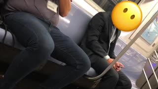 Man on train taking pictures of people