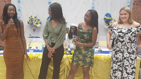 Lorraine's best friends congratulating her during thegraduation party