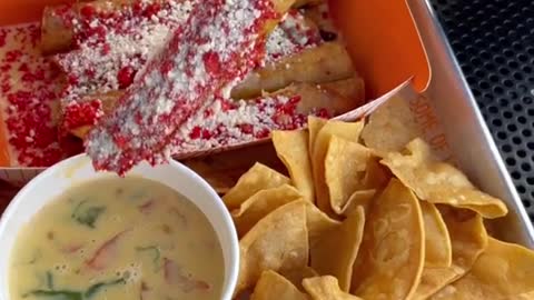Handmade Taquitos with hot Cheetos and queso. Who else like hot Cheetos