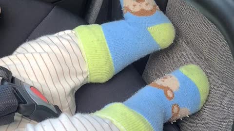 kicking cute baby foot on the car