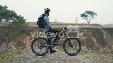 Athlete Man Resting From Riding A Mountain Bike In The Hill 1