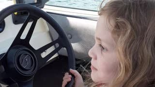 8 year old daughter, Abbi, driving our boat