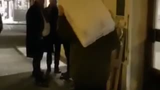 Drunk guy yells at crowd with boxes on his head