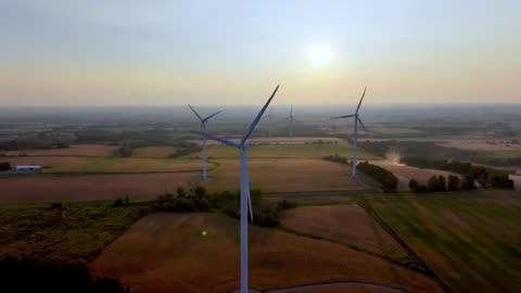 Wind turbines at sunset reveal the majestic beauty of wind farm