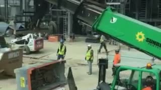 Operator picks up trash can and dumps it