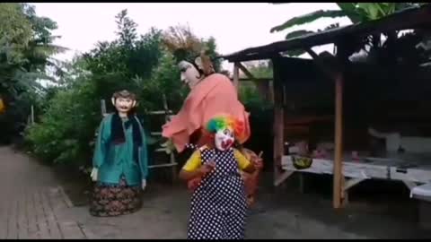 big doll dancing with a very funny clown