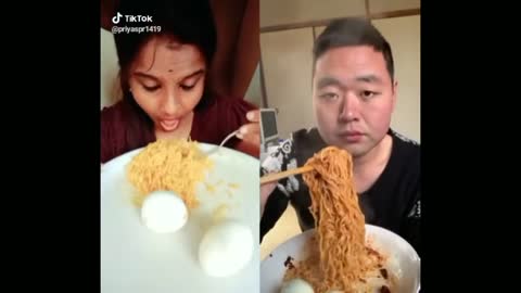 Intense Food Eating between chinese and Indian man