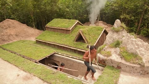 Building underground hut with grass roof & fireplace with clay