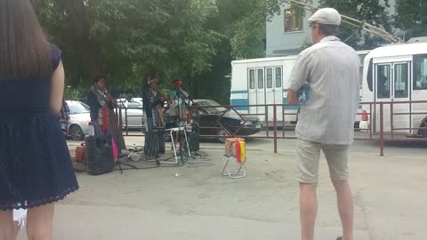 Strolling musicians from Cuba play on the sidewalk in Russia