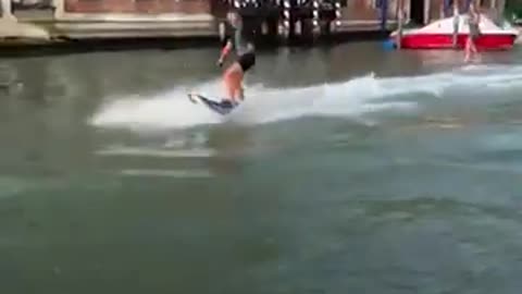 Surfers spark outrage for surfing down Venice’s Grand Canal