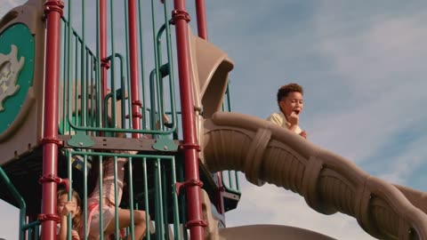 Children sliding down a slide