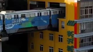 A train that runs through residential apartments in China.