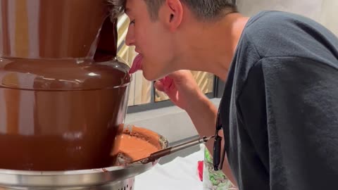 Guy Trying to Lick Chocolate Fountain Fails
