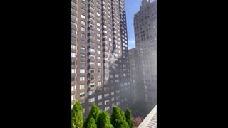 Footage shows person dangling from window in NYC fire