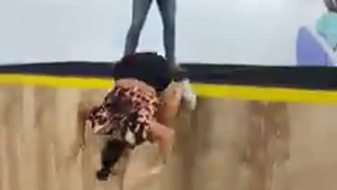 Girl Falls to the Ground Trying a Pull Over on a Trampwall