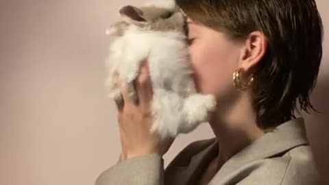 .Woman Holding a Rabbit Close to Her Face