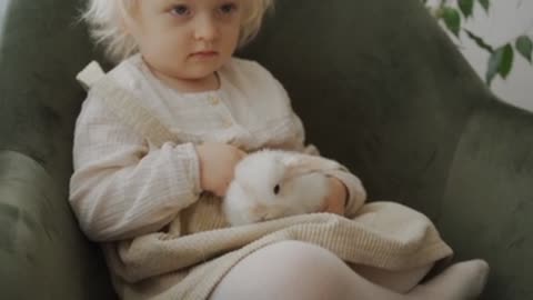 A Child Playing with Rabbit