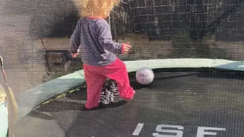 Little Girl with Wild Hair Plays on Trampoline