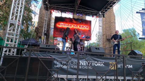 A good rock band playing on the Las Vegas strip in front of New York New York.