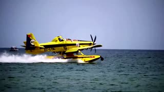 Firefighting seaplane refills water off Spanish beach