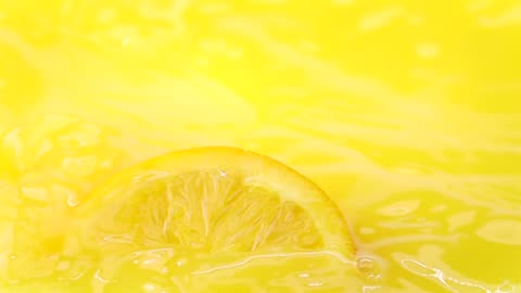 Slice of oranges falling into the juice