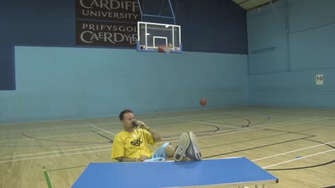 Guy Finger Spins Basketball Then Lands 3 Pointer Back Turned Sipping a Drink