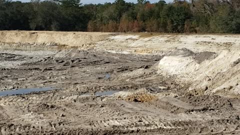 Digging up of edge of North Black Creek Middleburg Florida