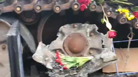 Laying flowers at the destroyed Russian tank in Berlin.