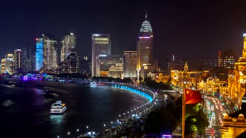 Shanghai river and city skyscrapers illuminated