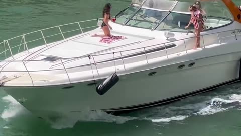 Girls attempting the famous Balancing beam walk to the bow of a Sundancer 540