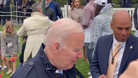Joe Biden has a costumed Easter Bunny handler moving him along