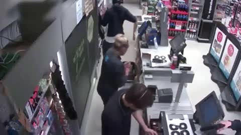 CCTV footage of store robbed on gunpoint - robbery video L A usa