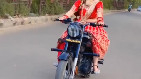 Indian beauty riding royal Enfield bike in traditional look