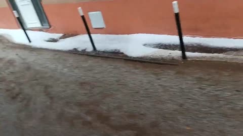 River of Mud Passing by Houses