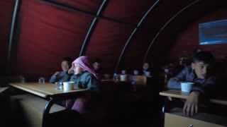 Children Gather Inside Tent To Watch Cartoons