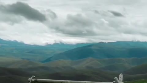 Chinese girl swings on a swing in the mountains and on the sea, Adorable views