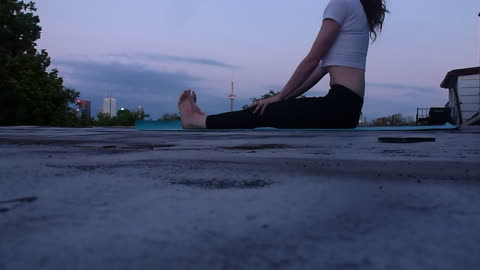 Girl does yoga on the roof