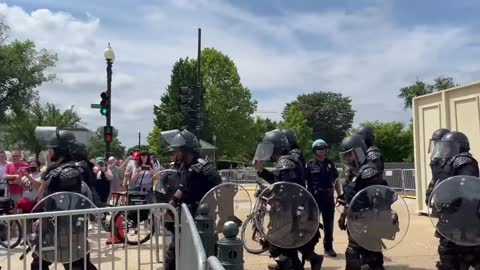 Police in riot gear make their way to the U.S. Supreme Court