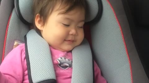 Baby fakes sleeping in order to stay in car