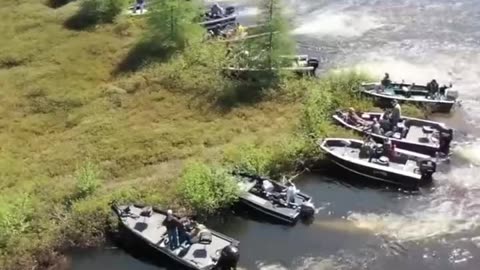 Boat owners moving a large floating island out of the way on Wisconsin's Lake