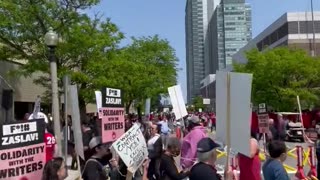 Protesters march in solidarity outside Boston University graduation as Warner Bros. CEO speaks