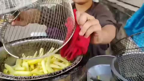 Young teen making French fries for sell what