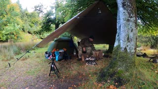 Early morning campfire under a tarp