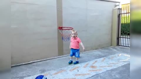 Cute child plays basketball