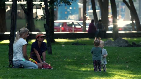 Two mamas and two babies playing in the park