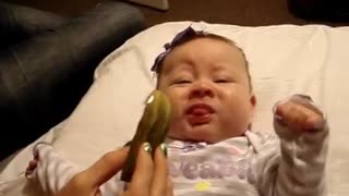 Adorable baby tries pickle for first time